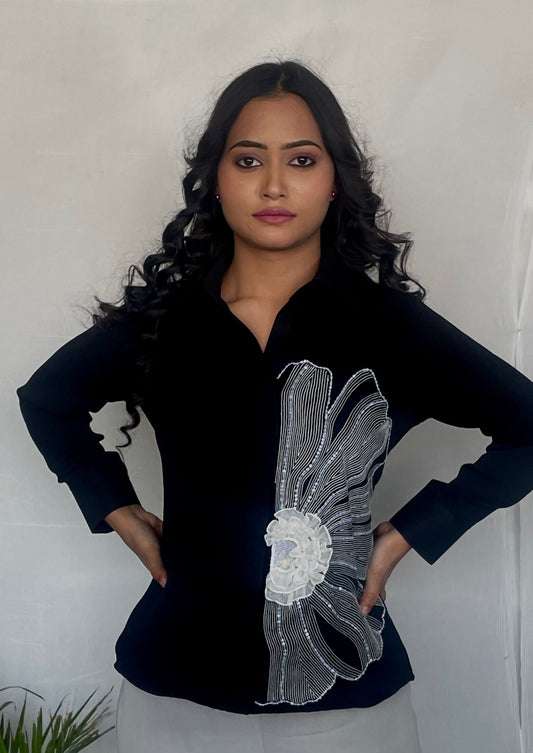 Black shirt with flower and ruffle detailing