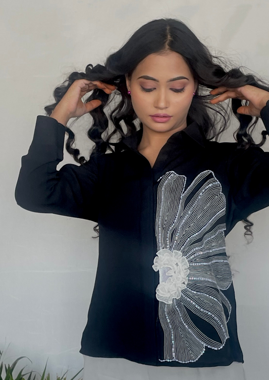 Black shirt with flower and ruffle detailing